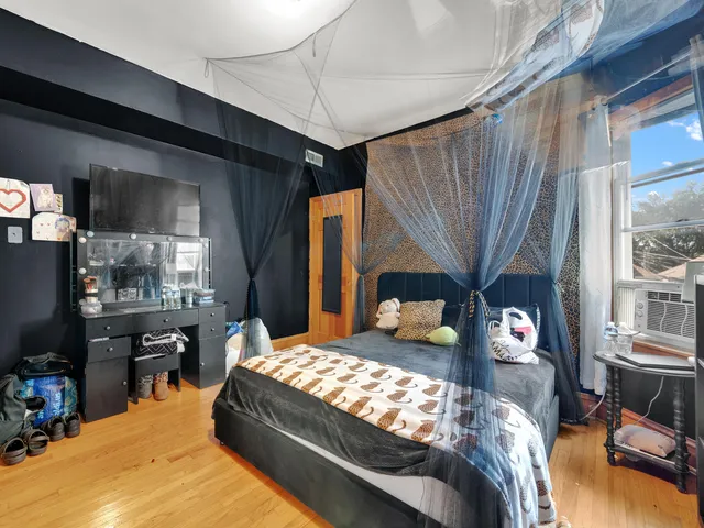 a bedroom with bed and a large window