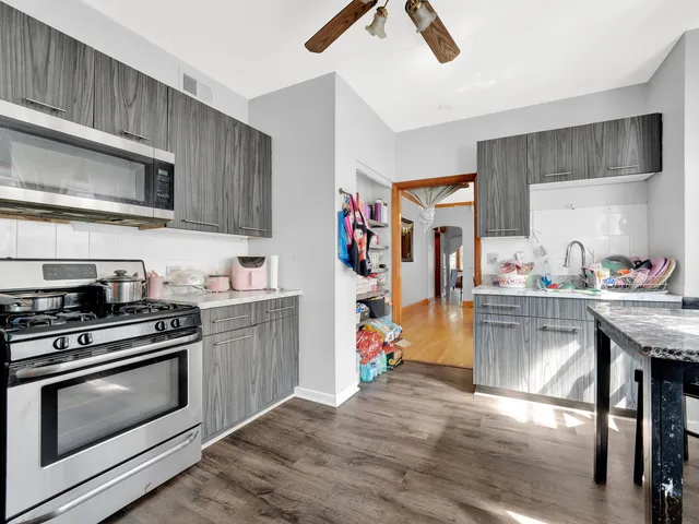 a kitchen with stainless steel appliances granite countertop a stove and cabinets