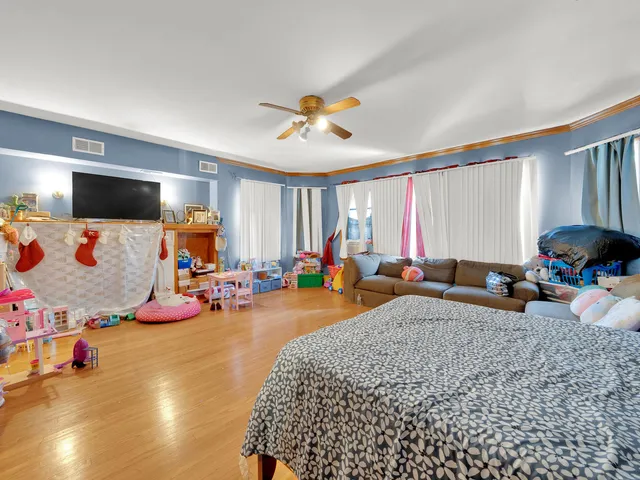 a bedroom with furniture and a flat screen tv