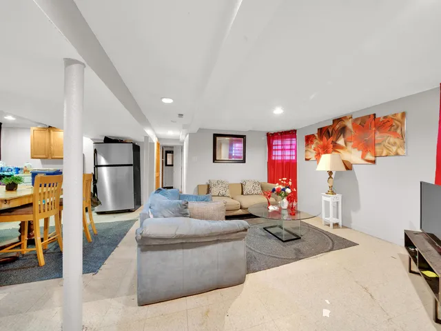 a living room with furniture and kitchen view
