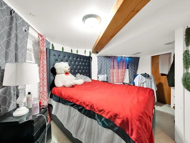 a bed sitting in a bedroom next to a lamp