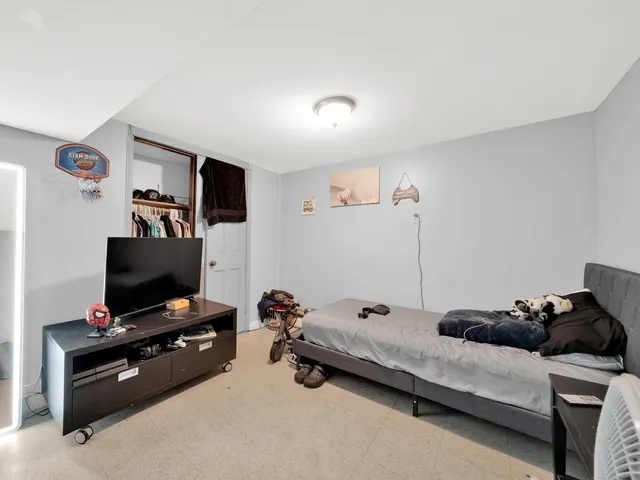 a bedroom with furniture and a flat screen tv