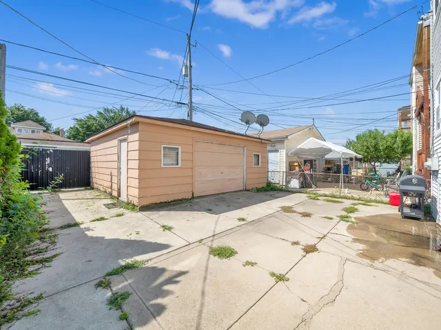 a patio with a table and chairs under an umbrella