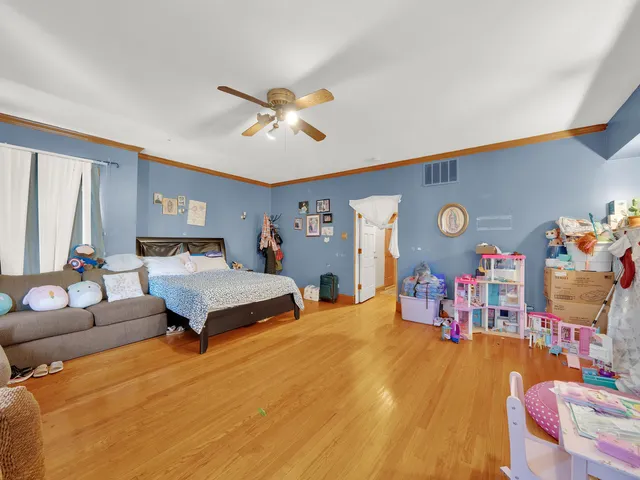 a bedroom with furniture and a wooden floor