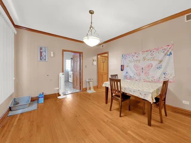 a view of a livingroom with furniture a chandelier and wooden floor