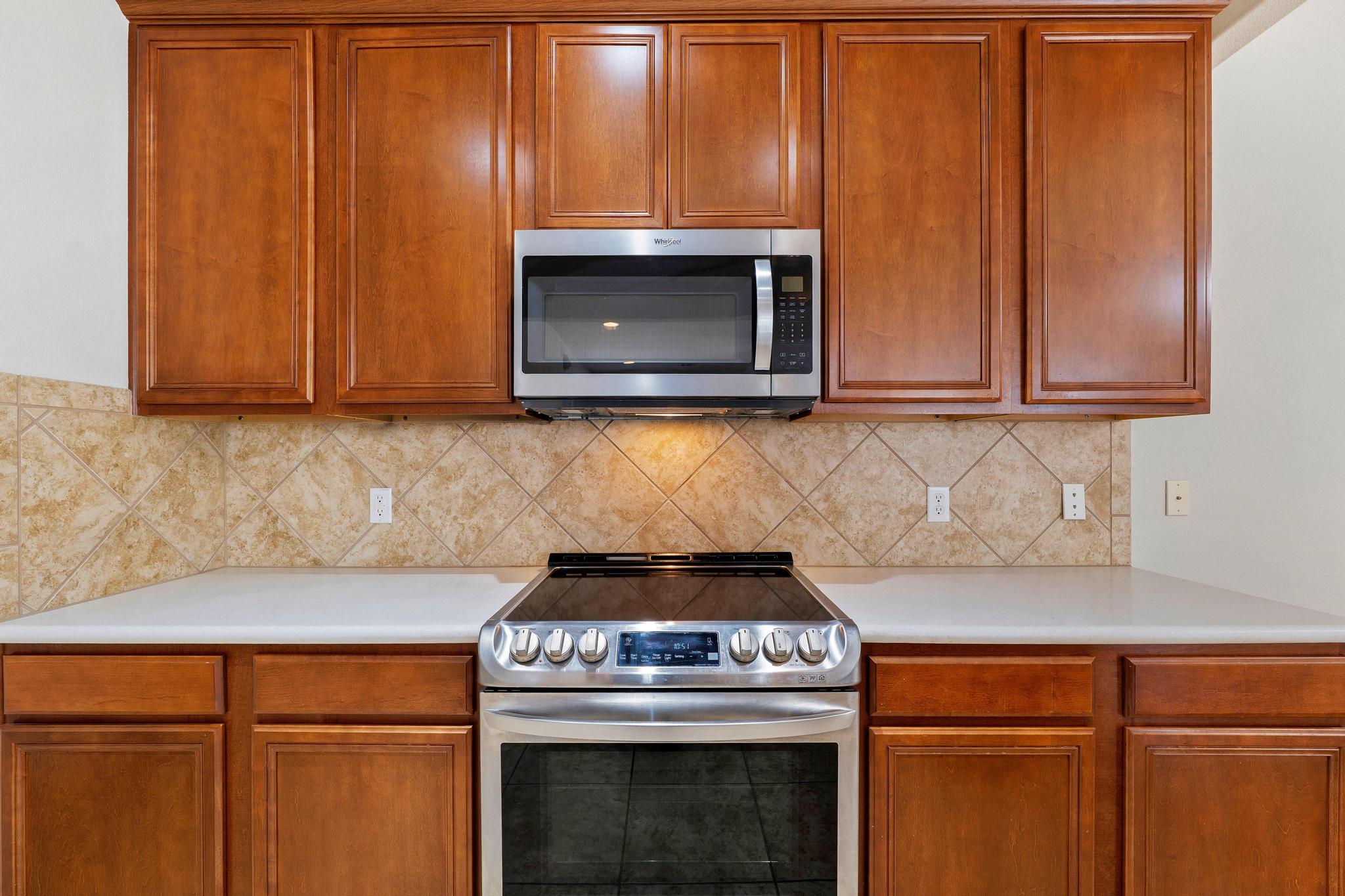520 Mill Pond Path Georgetown, TX 78633 - Photo 19 of 38 A contemporary kitchen features sleek cabinetry, practical countertops, and integrated stainless steel appliances.