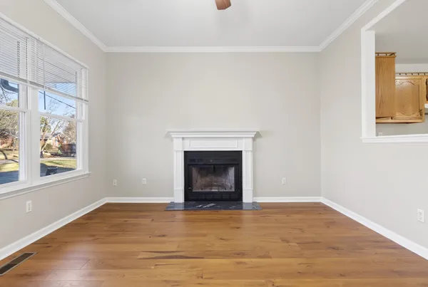a large kitchen with a white stove top oven and cabinets