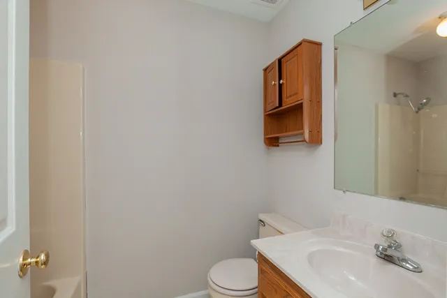 a bathroom with a sink toilet and mirror