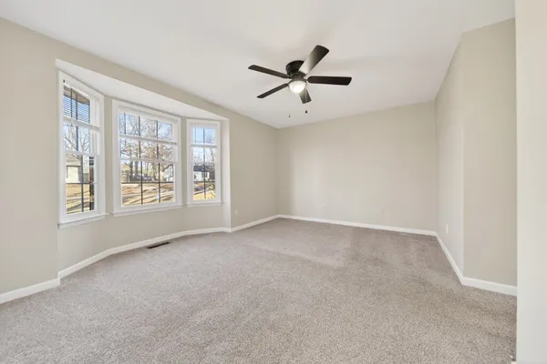 a view of a house with a wooden fence