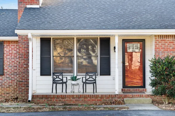 an empty room with wooden floor cabinet and windows