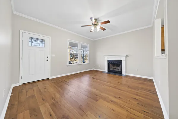 a view of empty room with wooden floor