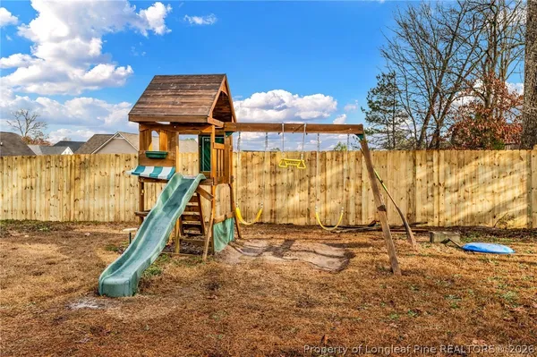 a backyard of a house with table and chairs