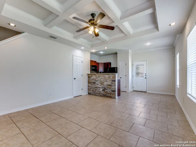 a view of a livingroom with a ceiling fan and window