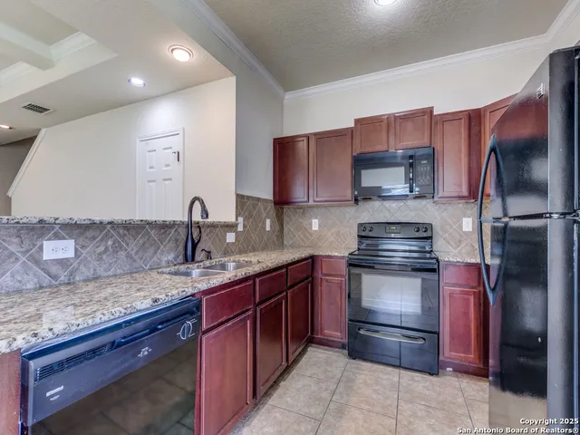 a kitchen with a sink stove and refrigerator
