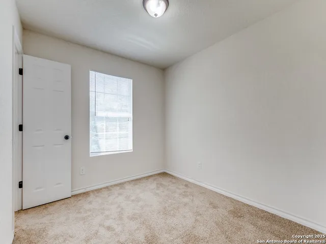 an empty room with windows and closet