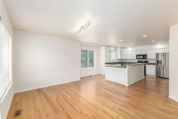 a view of kitchen with refrigerator and window