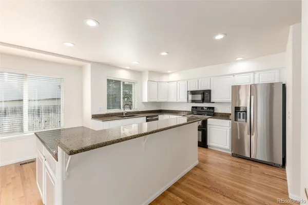 a kitchen with refrigerator and window