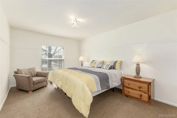 a spacious bedroom with a bed and a couch