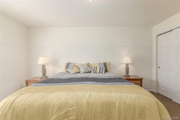 a bedroom with a bed and a lamp