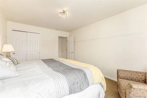 a bedroom with a bed and a couch