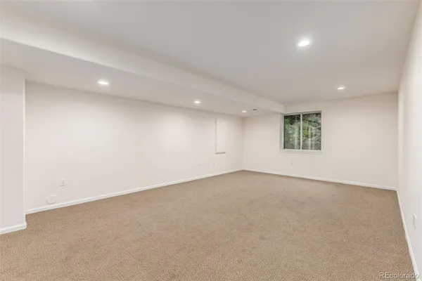 an empty room with a empty space and windows