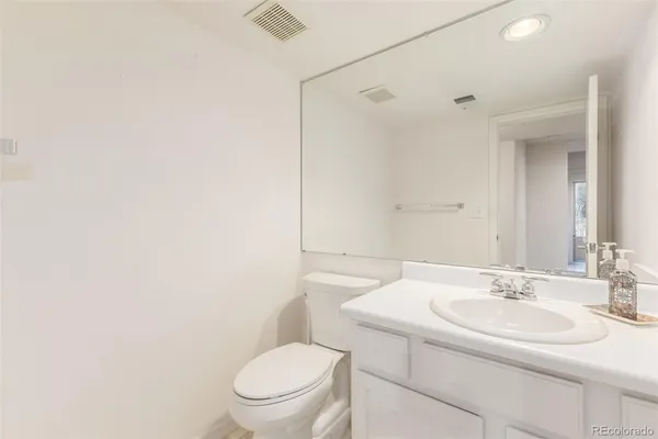 a bathroom with a sink toilet and a mirror