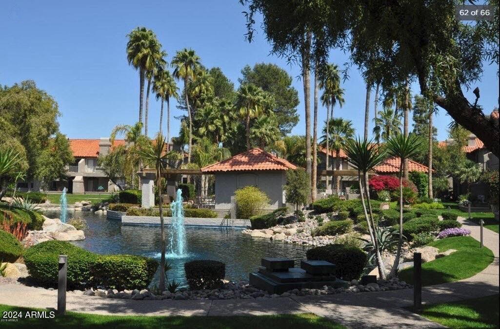 a view of a water fountain in front of a house