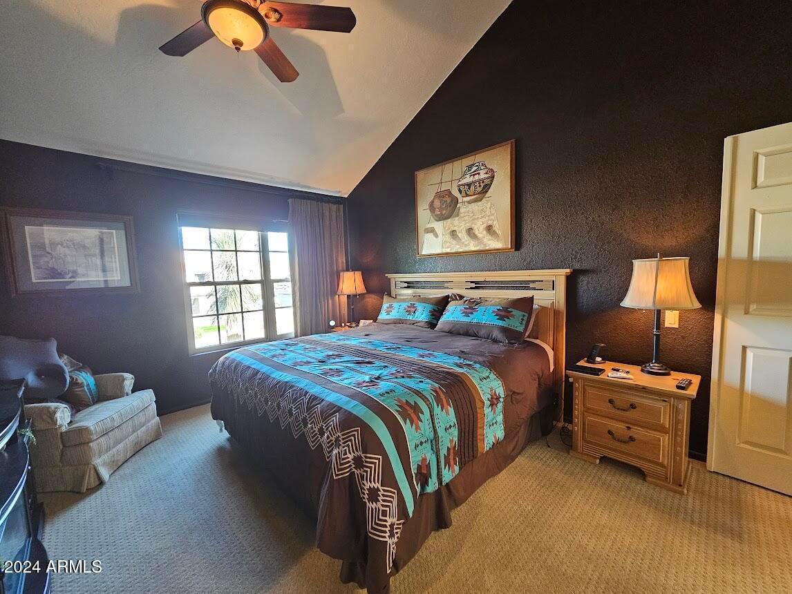 10015 East Mountain View Road, Unit 1002 Scottsdale, AZ 85258 - Photo 15 of 24 a bedroom with a bed and wooden floor