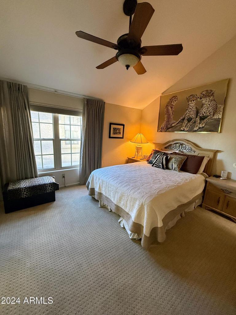 10015 East Mountain View Road, Unit 1002 Scottsdale, AZ 85258 - Photo 18 of 24 a bedroom with a bed and a couch