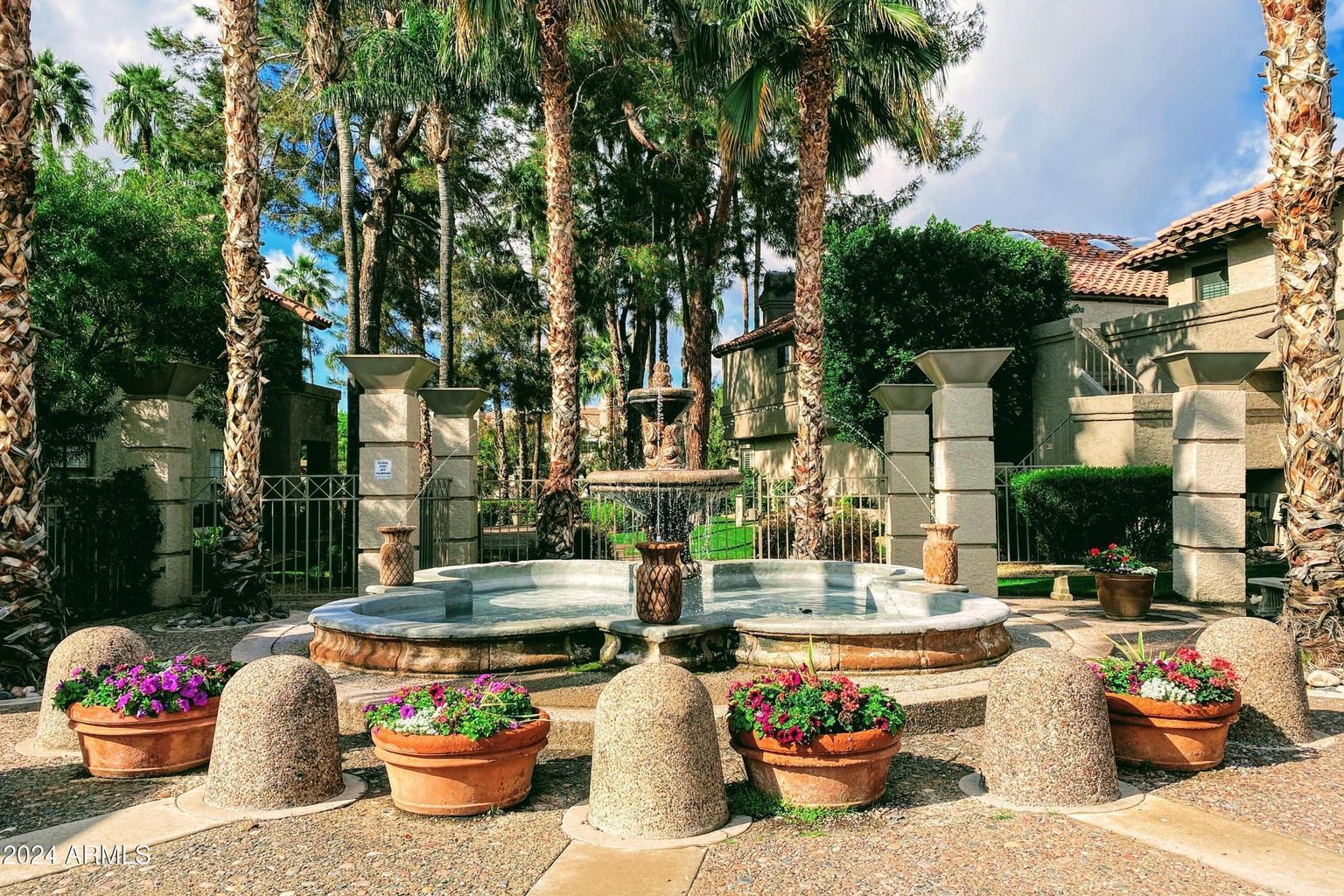 10015 East Mountain View Road, Unit 1002 Scottsdale, AZ 85258 - Photo 2 of 24 a wooden bench sitting in front of a building