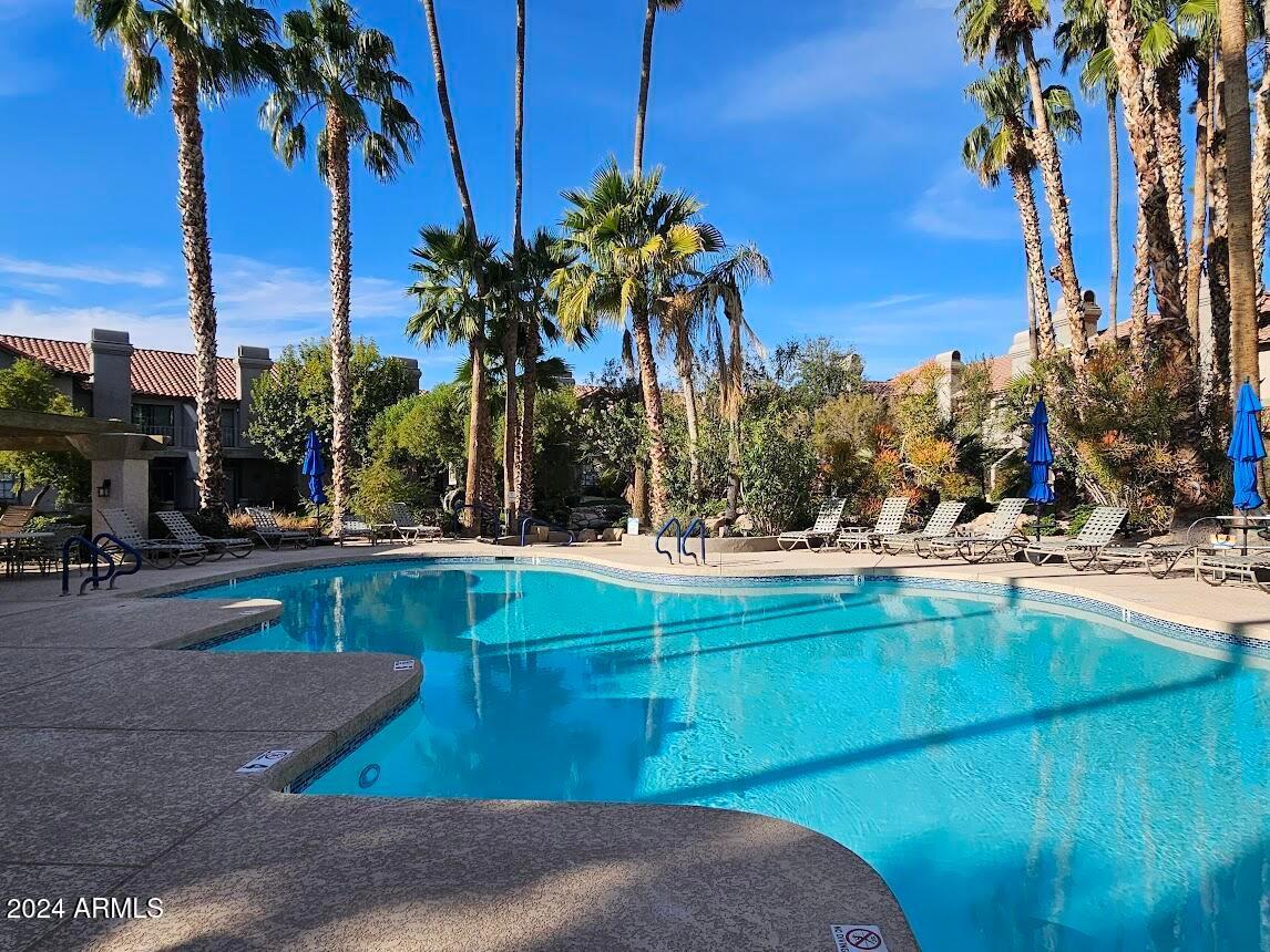 10015 East Mountain View Road, Unit 1002 Scottsdale, AZ 85258 - Photo 22 of 24 a view of swimming pool with a table and chairs