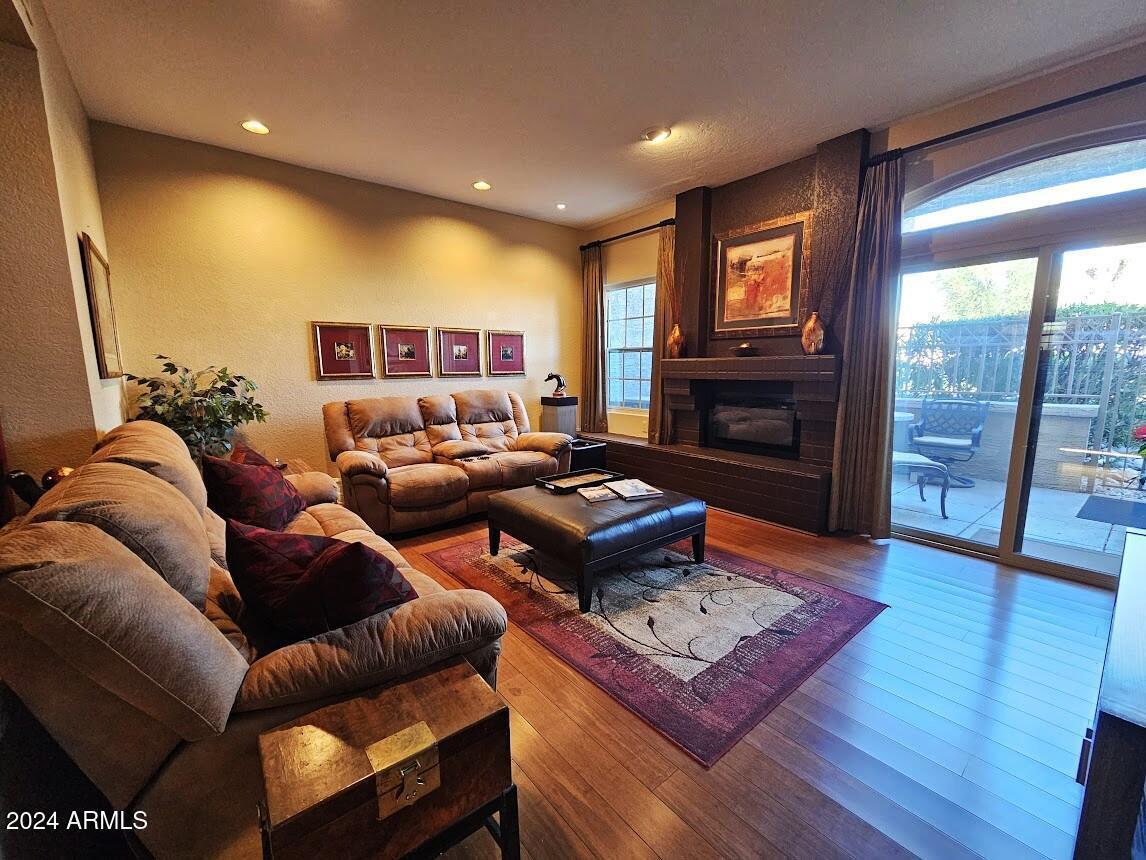 10015 East Mountain View Road, Unit 1002 Scottsdale, AZ 85258 - Photo 4 of 24 a living room with furniture and a fireplace