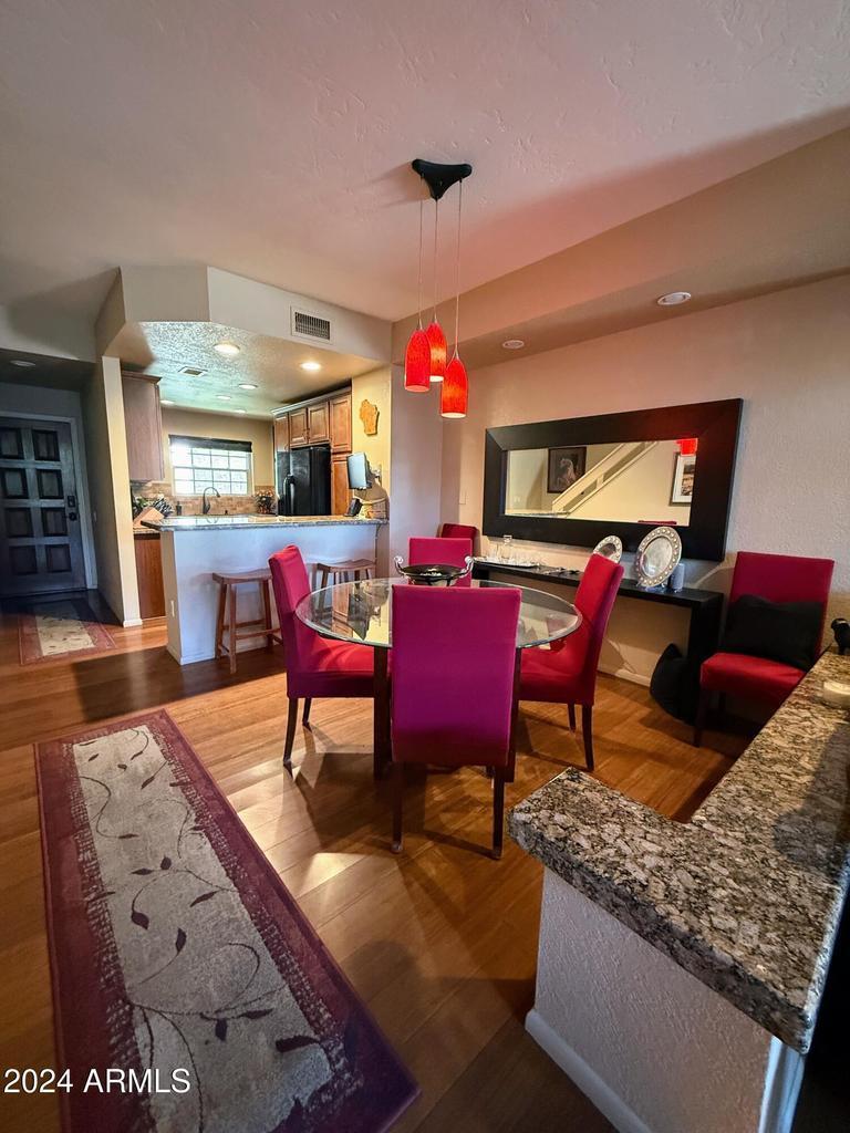 10015 East Mountain View Road, Unit 1002 Scottsdale, AZ 85258 - Photo 7 of 24 a view of a dining room with furniture