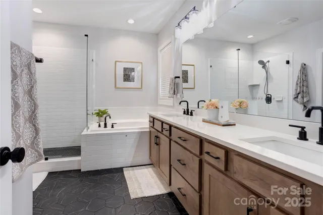 a spacious bathroom with a tub sink and mirror