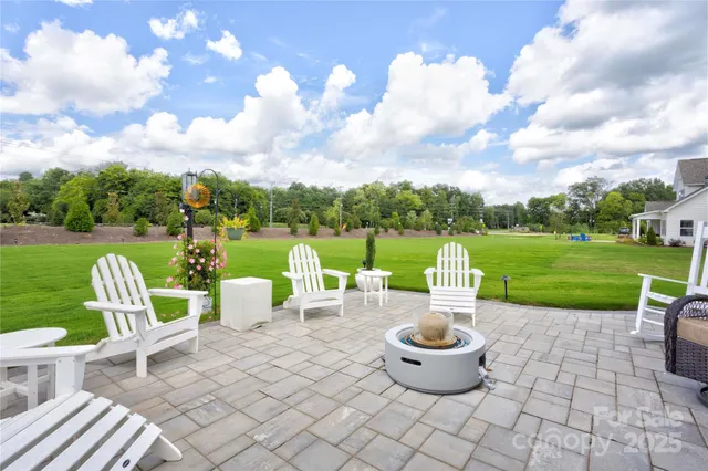 a view of a garden with furniture