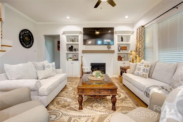 a living room with furniture a rug and a fireplace