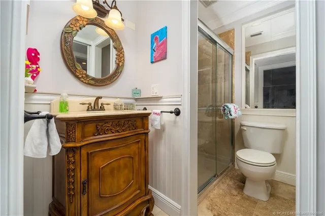 a bathroom with a toilet a sink and a mirror