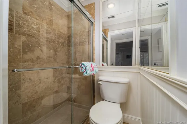 a bathroom with a toilet and a shower