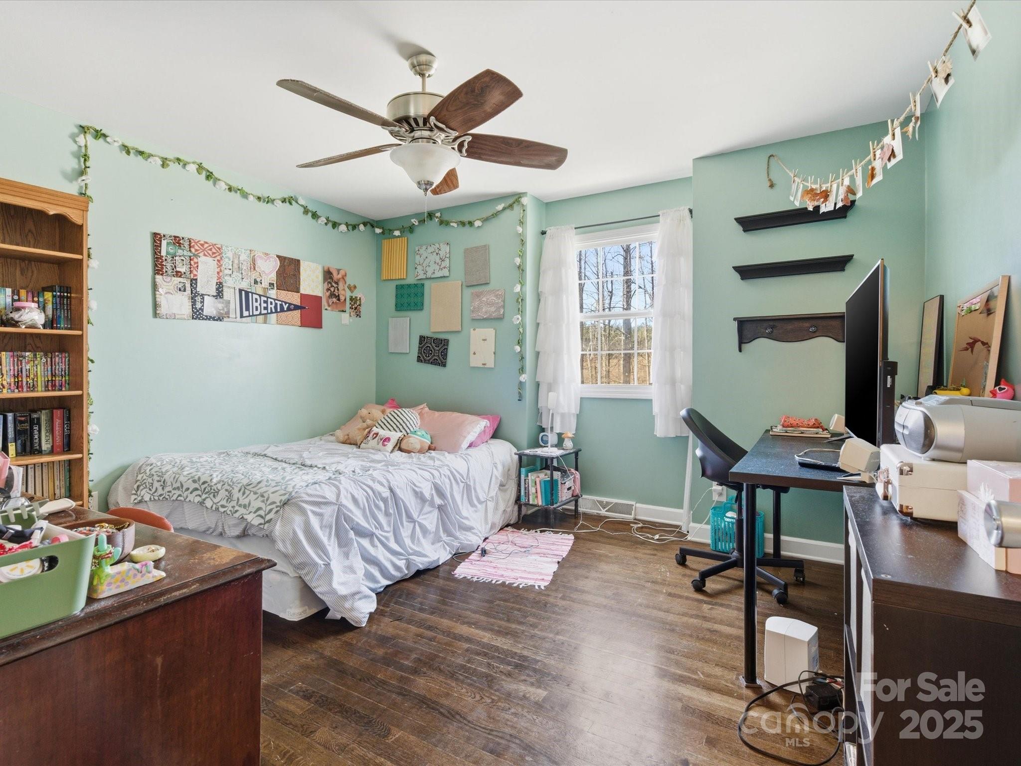 9941 Ferguson Road Charlotte, NC 28227 - Photo 20 of 29 a bedroom with a bed and a table in it