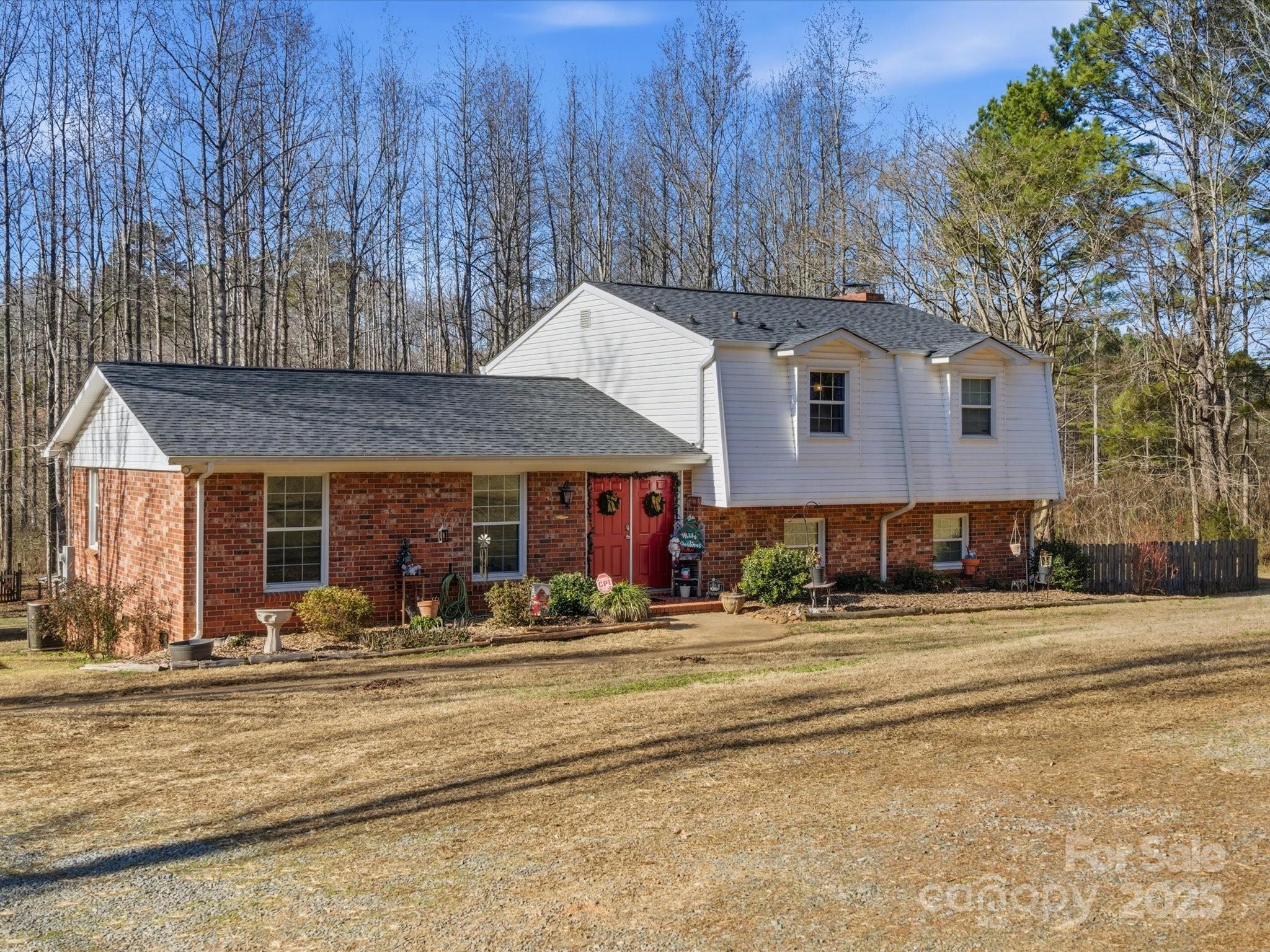 9941 Ferguson Road Charlotte, NC 28227 - Photo 2 of 29 a front view of a house with a garden