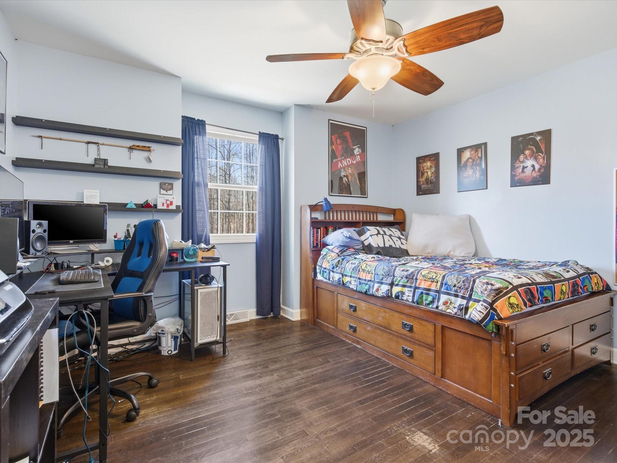 9941 Ferguson Road Charlotte, NC 28227 - Photo 21 of 29 a bedroom with a bed and a chandelier