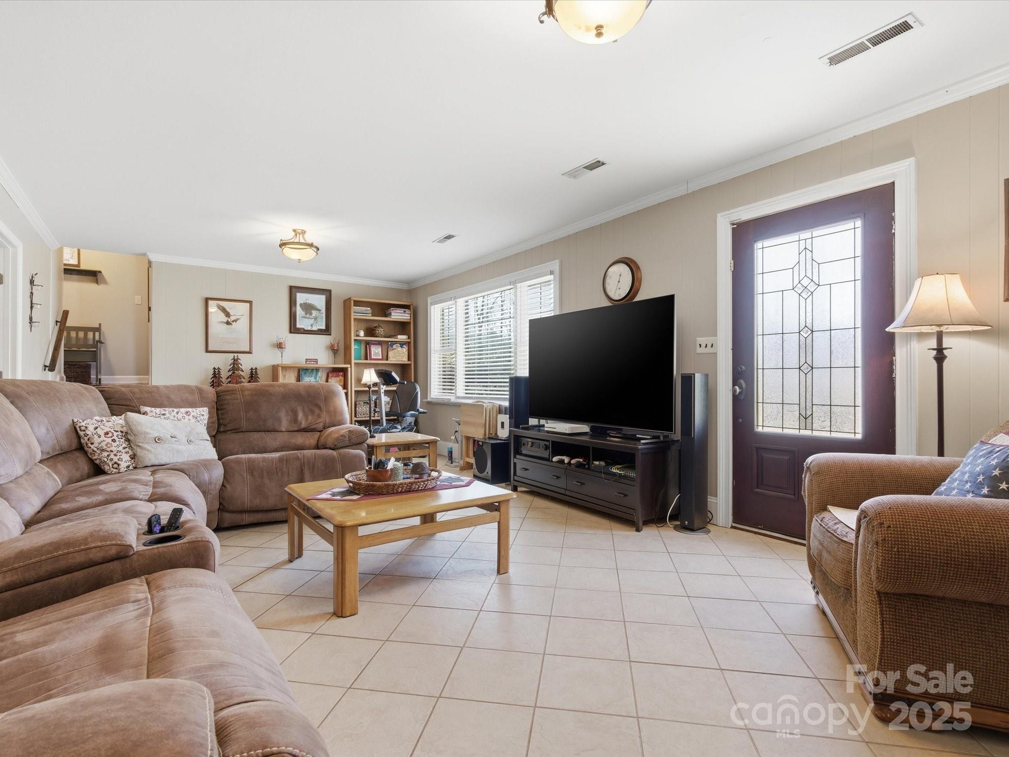 9941 Ferguson Road Charlotte, NC 28227 - Photo 25 of 29 a living room with furniture and a flat screen tv