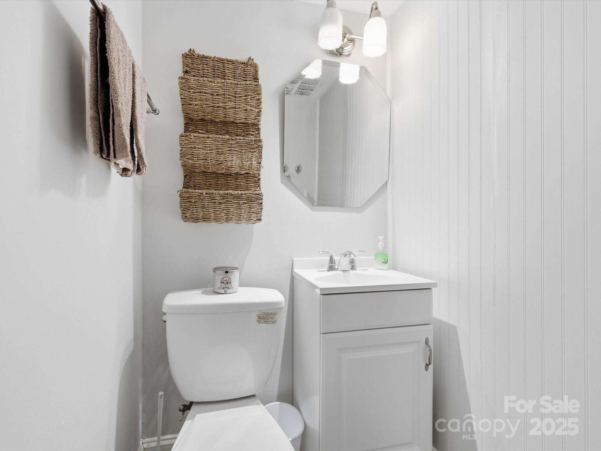 9941 Ferguson Road Charlotte, NC 28227 - Photo 28 of 29 a bathroom with a toilet a sink and a mirror