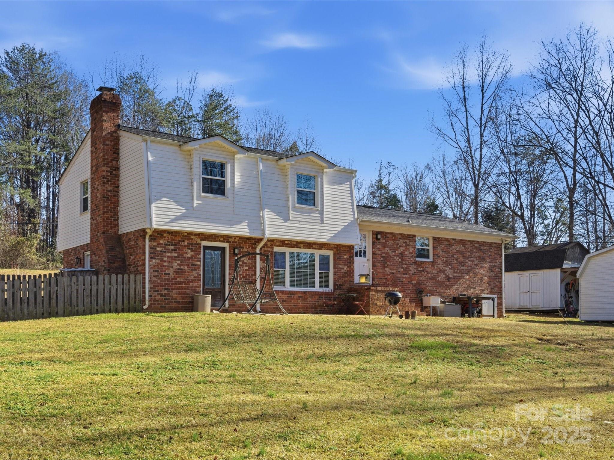 9941 Ferguson Road Charlotte, NC 28227 - Photo 5 of 29 a front view of a house with a garden