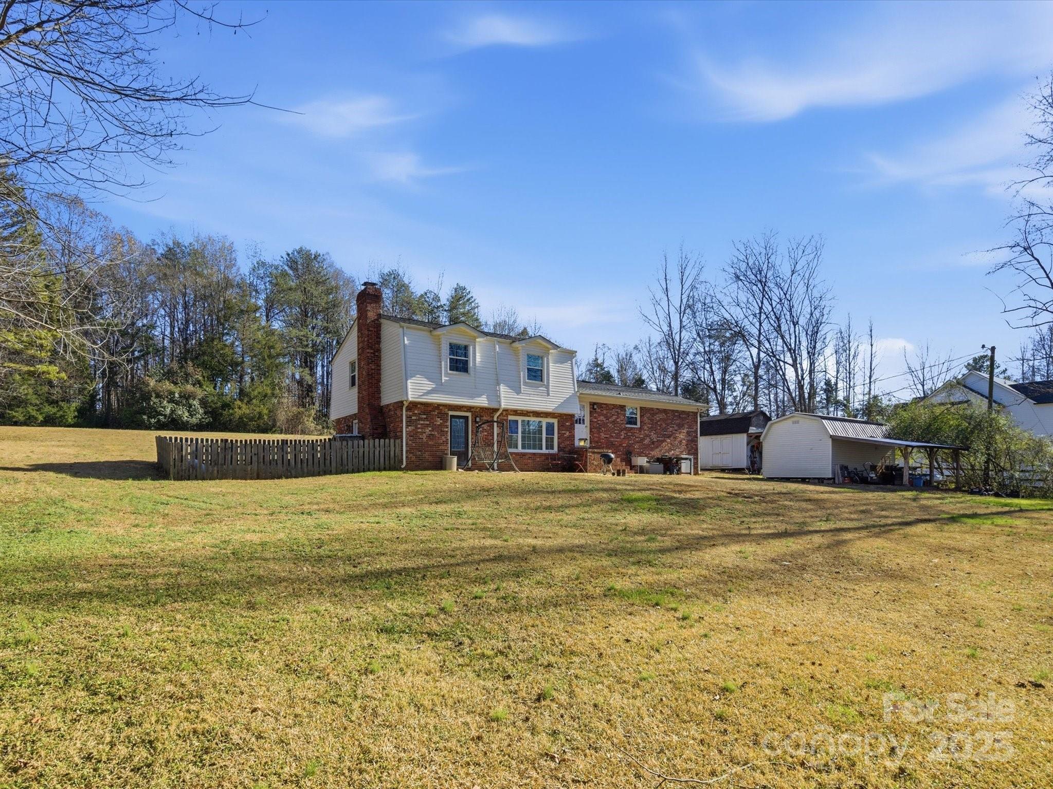 9941 Ferguson Road Charlotte, NC 28227 - Photo 7 of 29 a house with trees in front of it