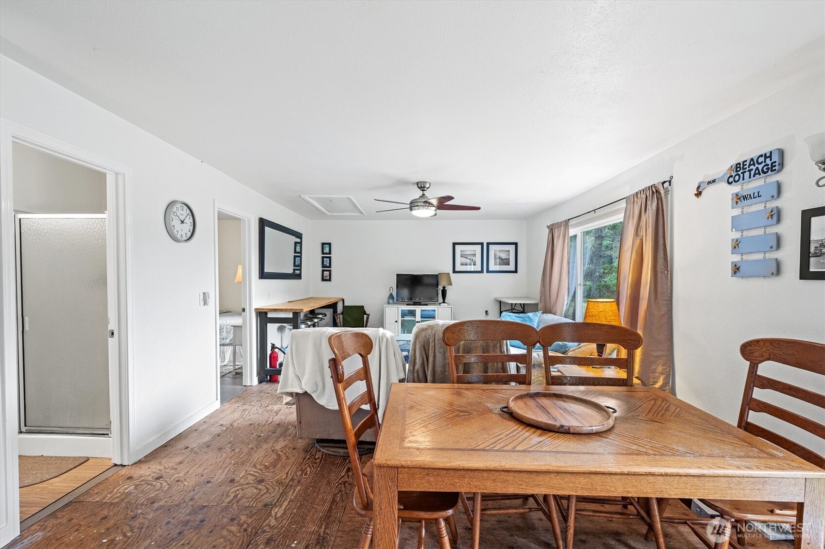 11303 Pacific Way Long Beach, WA 98631 - Photo 13 of 40 a view of a dining room with furniture a chandelier and wooden floor