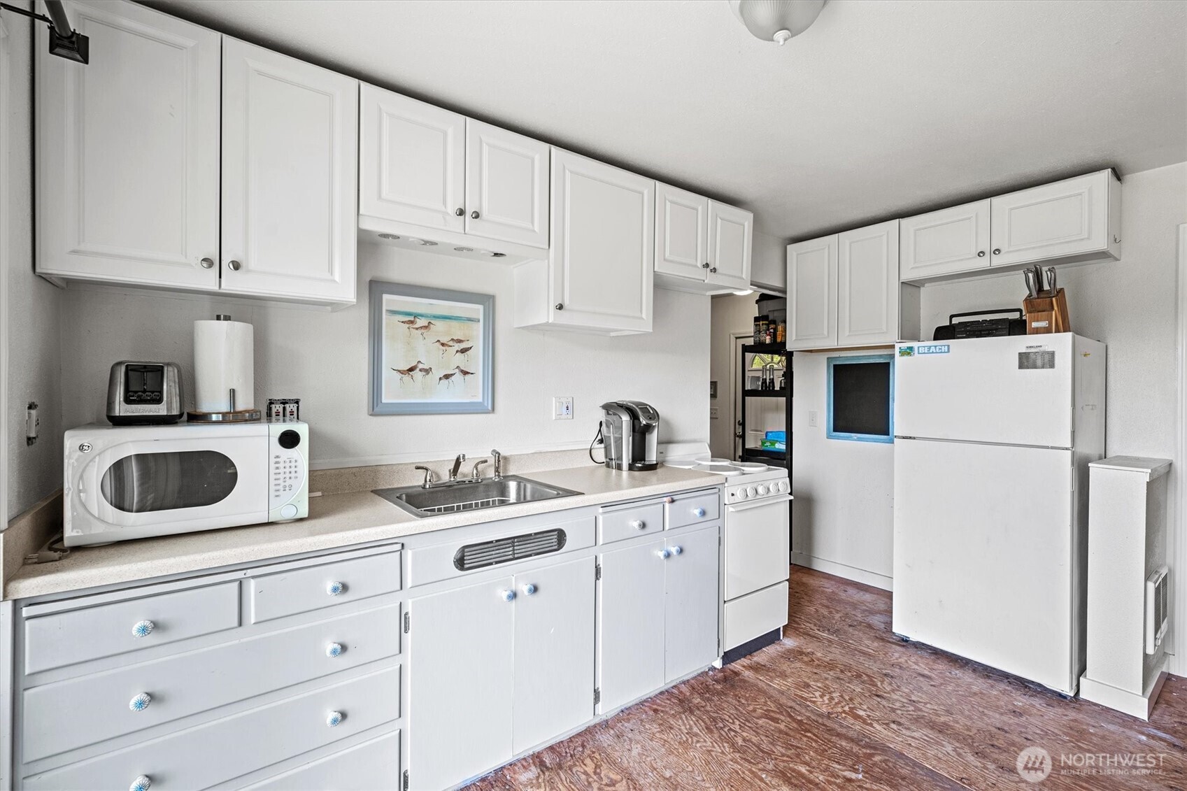 11303 Pacific Way Long Beach, WA 98631 - Photo 10 of 40 a kitchen with refrigerator a stove a sink and cabinets