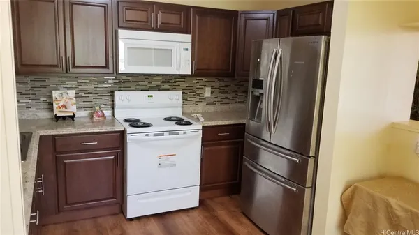 a kitchen with a refrigerator stove and sink