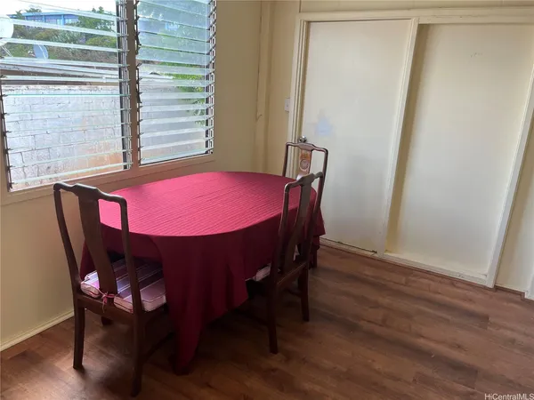 a view of a dining room with furniture and window