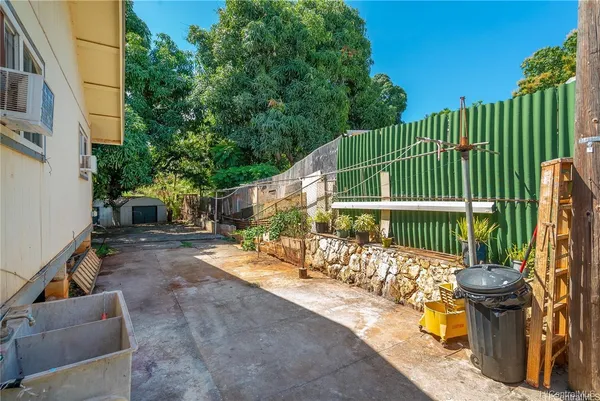 a view of a chair and tables back yard of the house